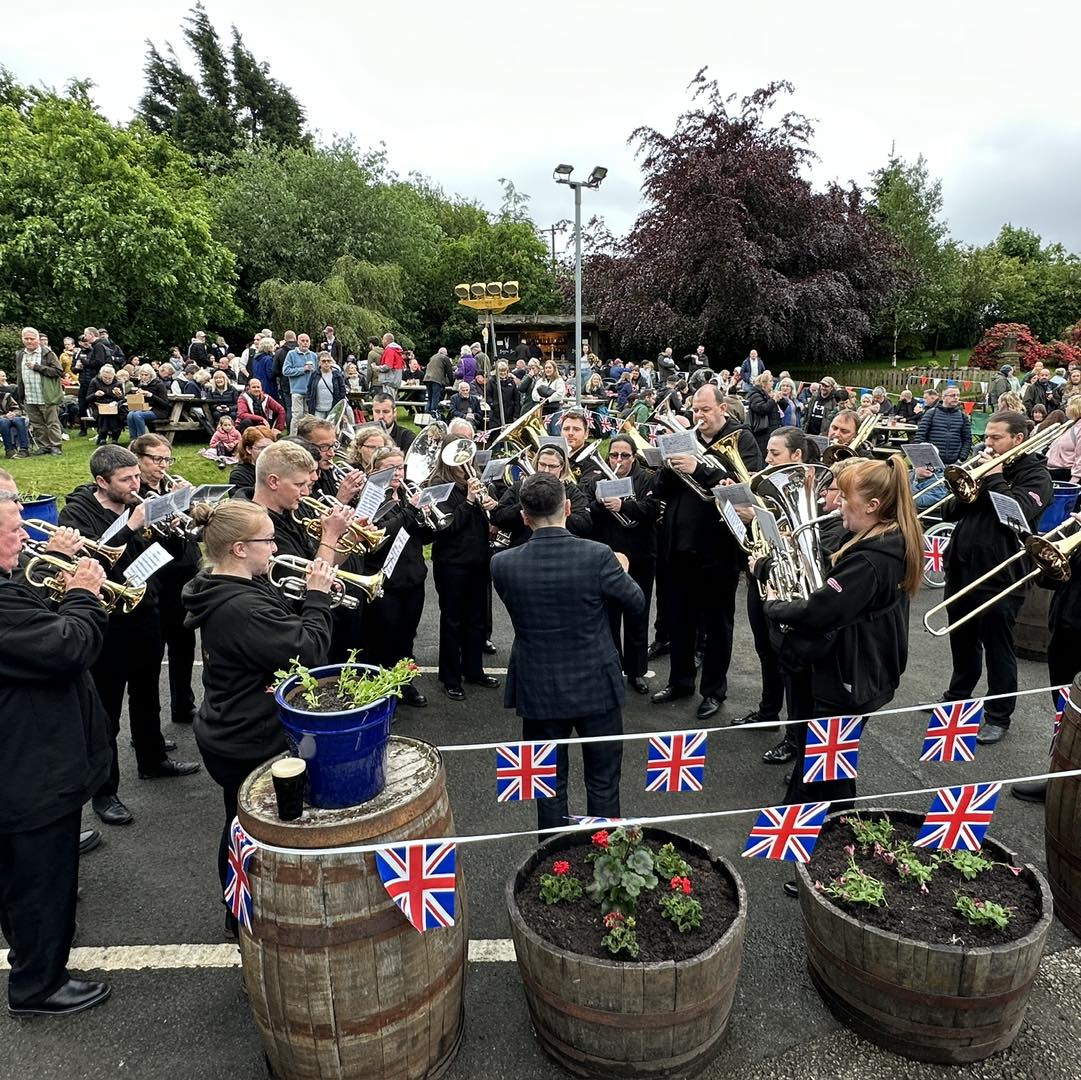 Middleton Band playing brass instruments at an outdoor community event